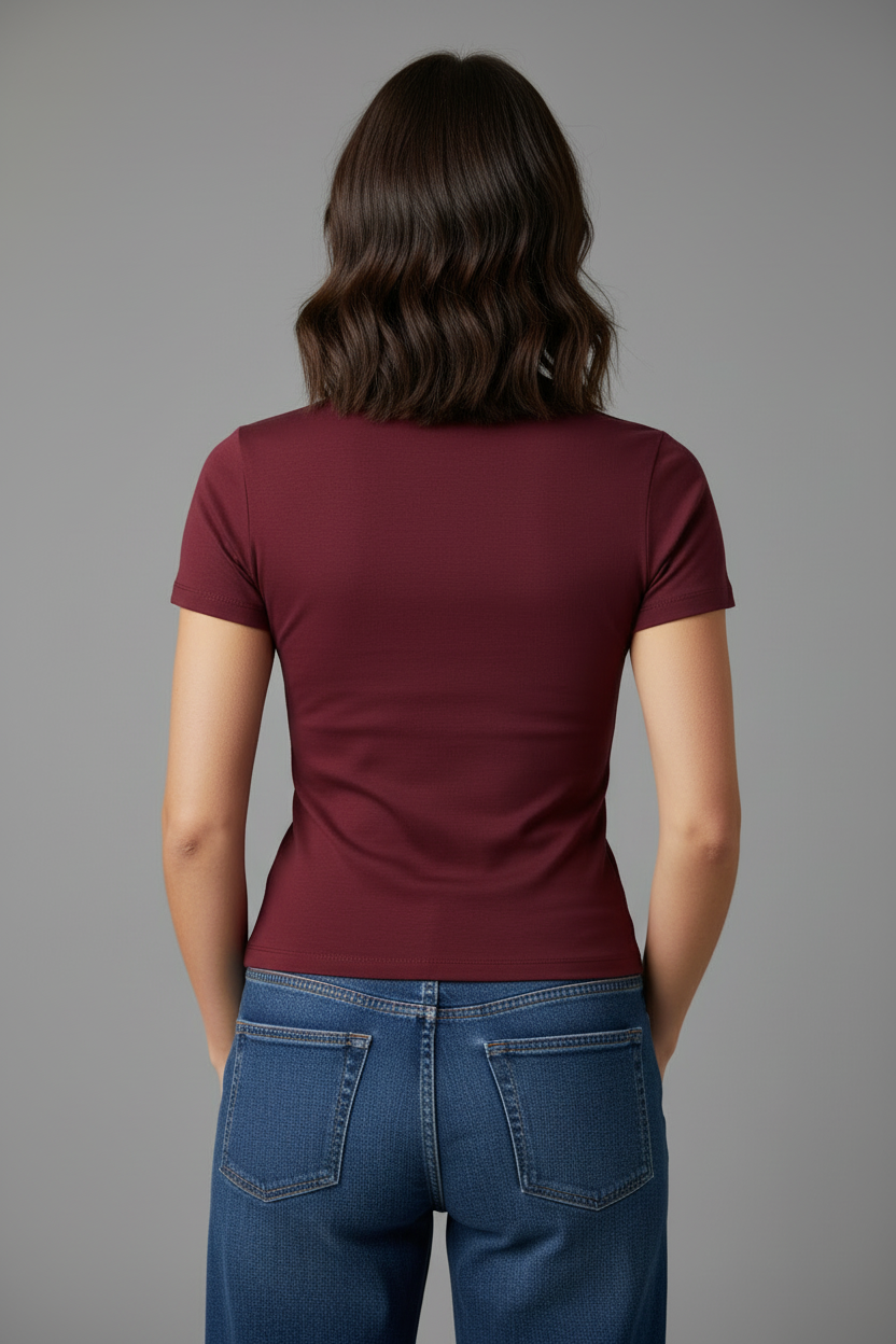 Model in burgundy t-shirt - back view thumbs in pockets