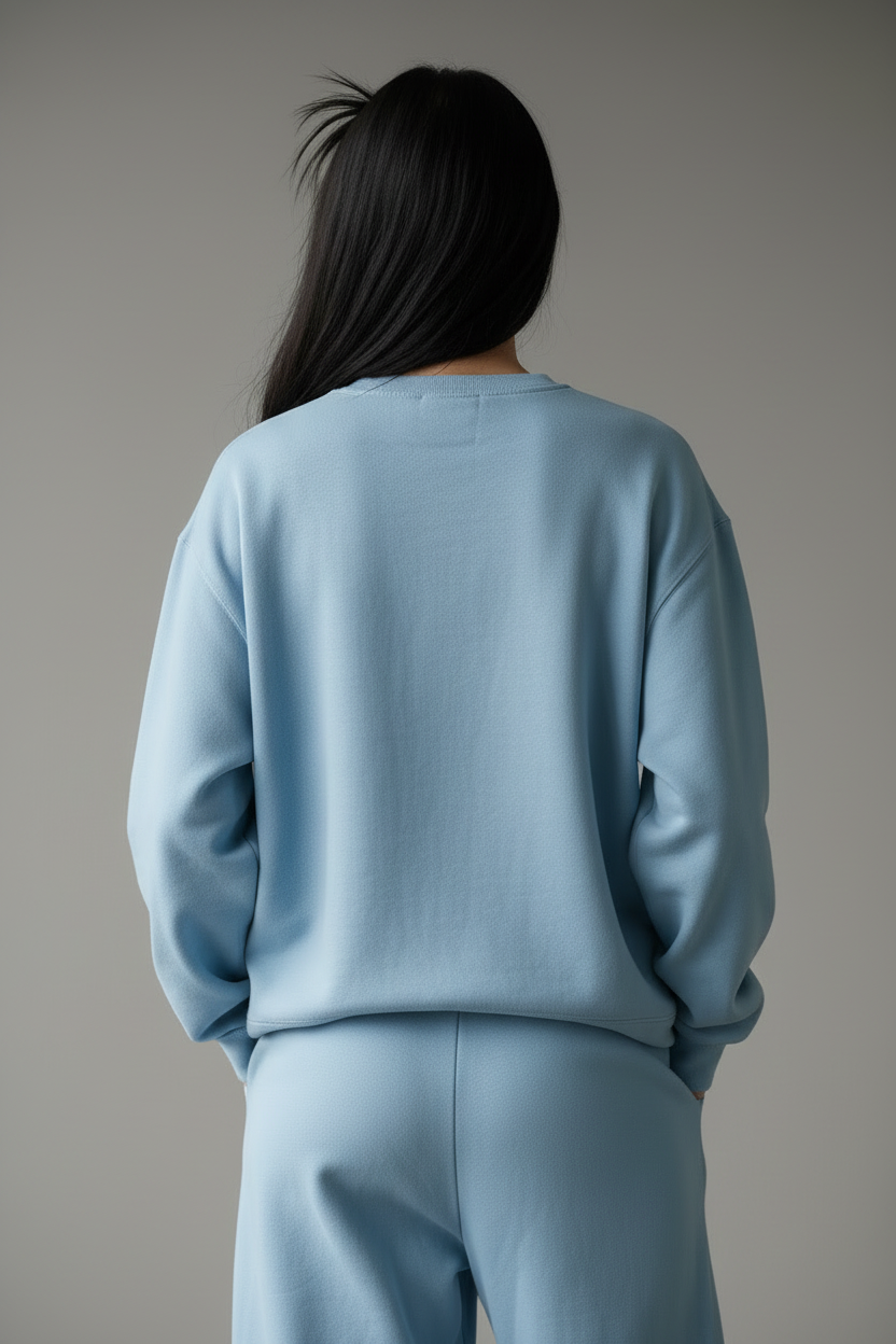 Model in light blue sweatshirt - back view hands clasped