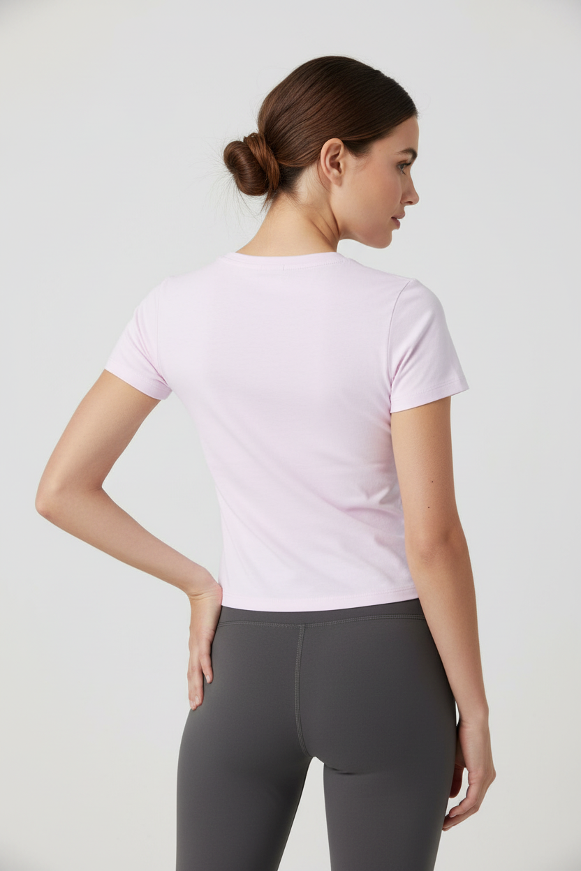 Model in light pink t-shirt - back view hand on hip