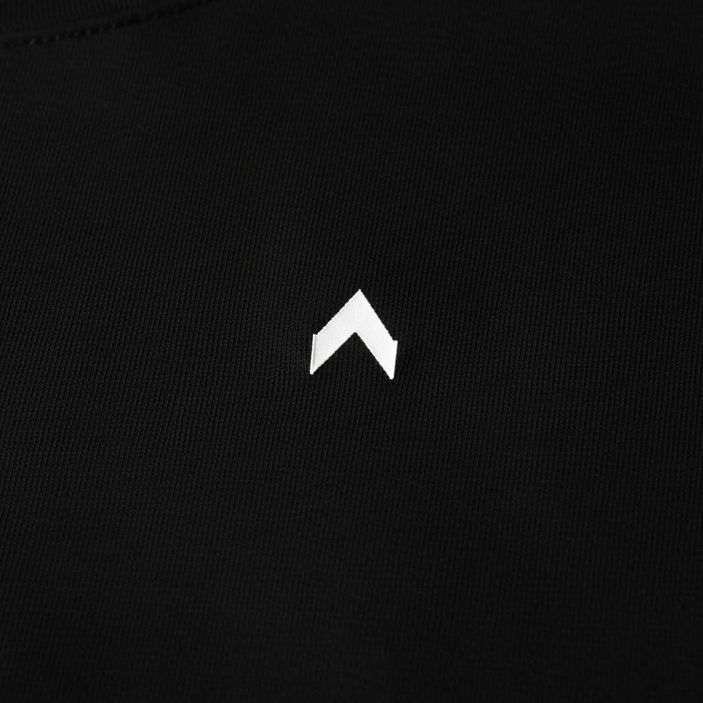 Premium black cotton shirt with white arrow logo close-up